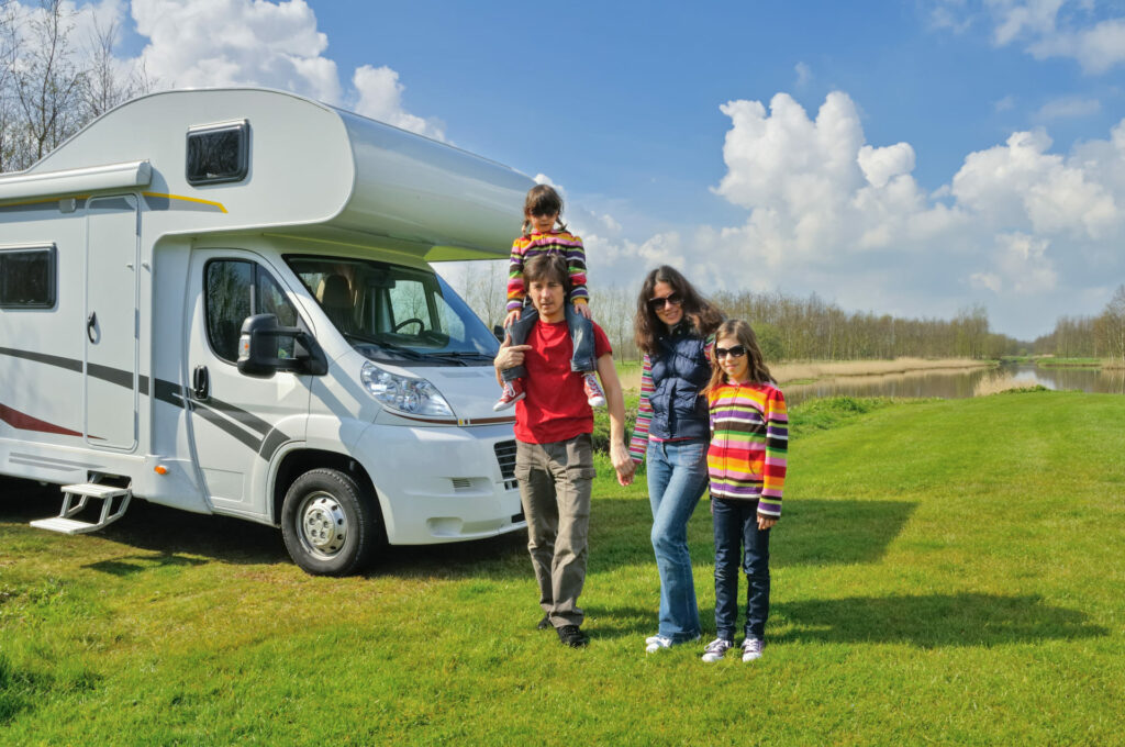 Family with their RV in a field