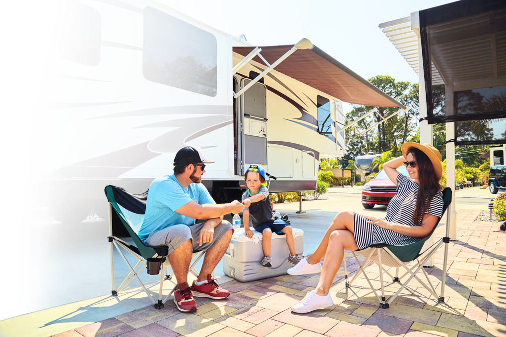 Family outside their RV in an RV park