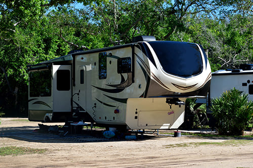 Trailerable motorhome in a dirt lot