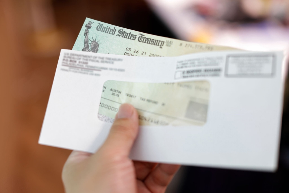 Person Holding a Tax Refund Check Ready to Make Down Payment on Boat or RV